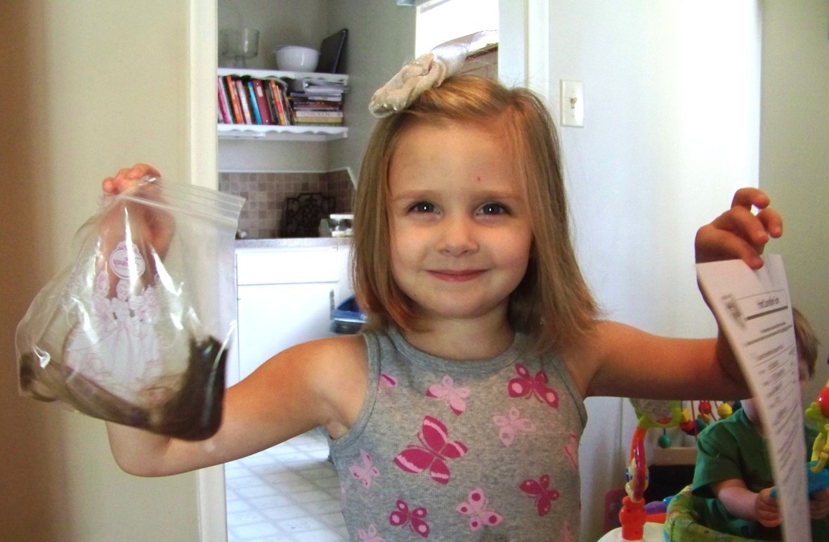 Katie holding her hair in a bag and her donation form