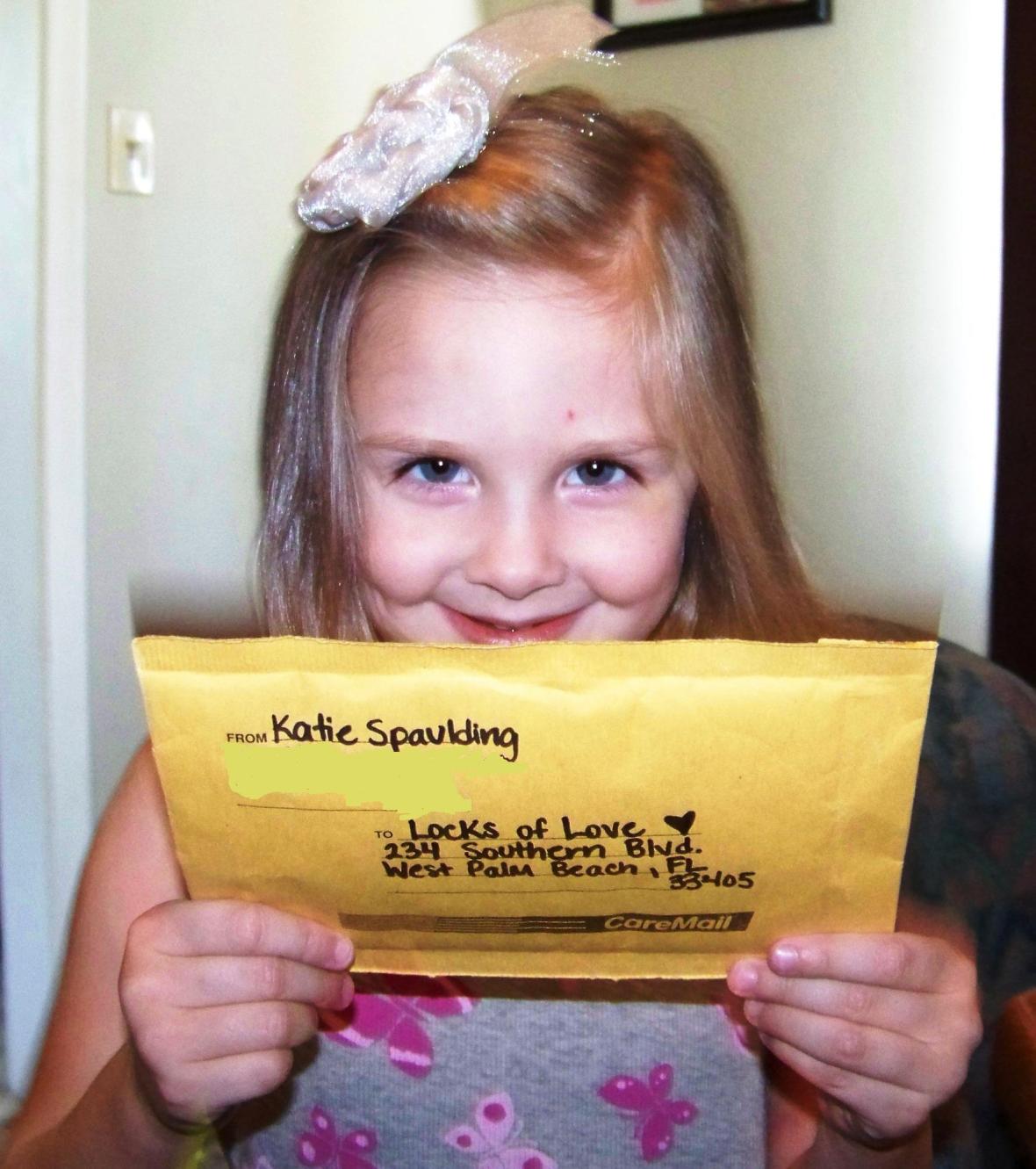 Katie holding the envelope to mail